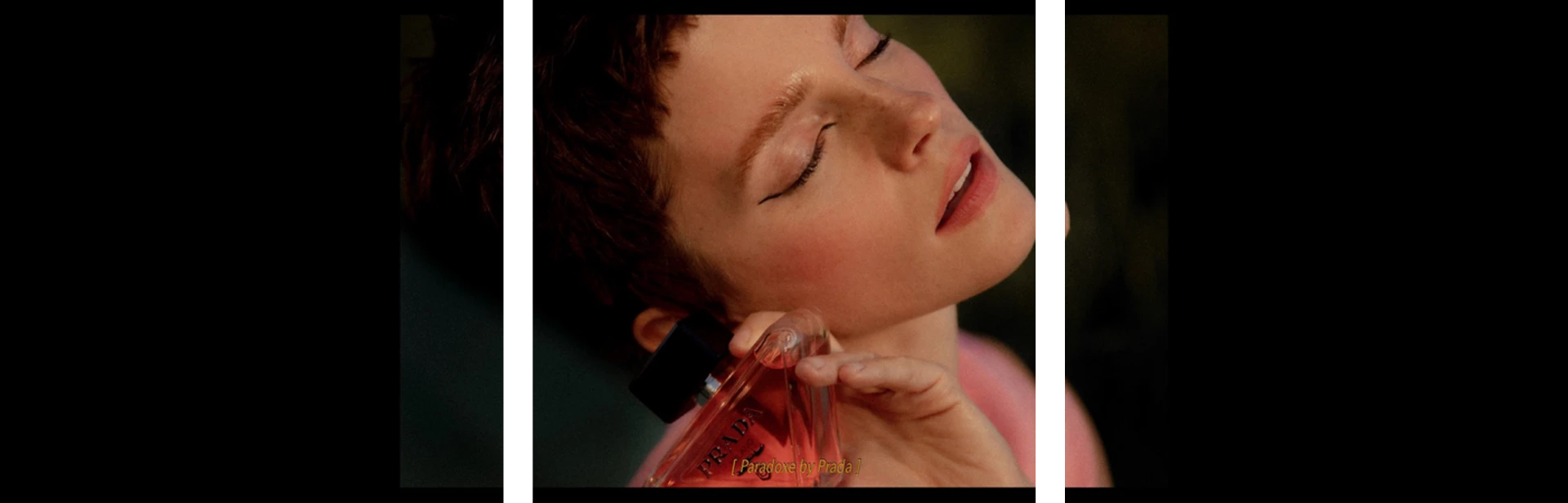 Emma Watson holding Prada Paradoxe fragrance